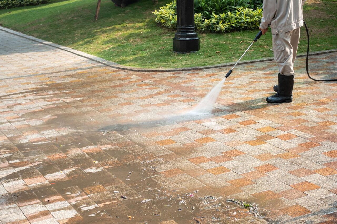 Before and after high pressure cleaning on outdoor paving